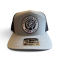 Kingston Oak Soap Co. weatherproof hat, front view, gray front with leatherette seal patch and black perforated side panels