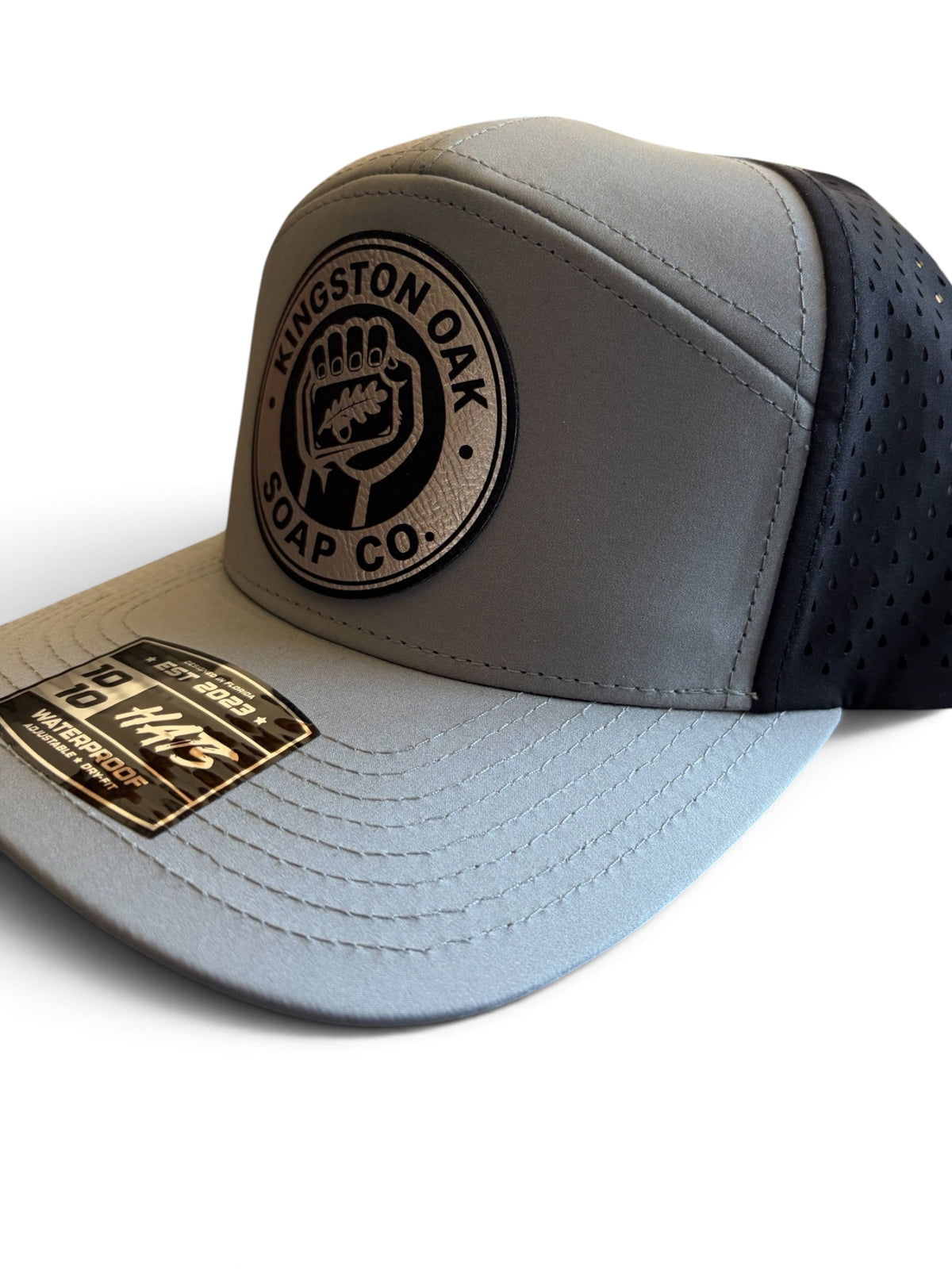 Kingston Oak Soap Co. weatherproof hat, angled side view showing curved gray brim and black perforated panels